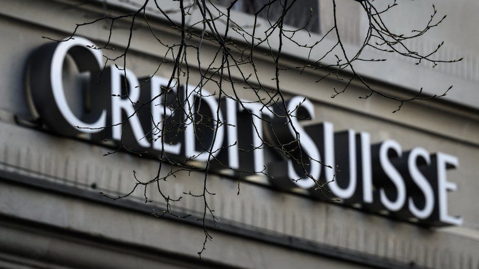 Credit Suisse logo with overhanging bare branches in foreground