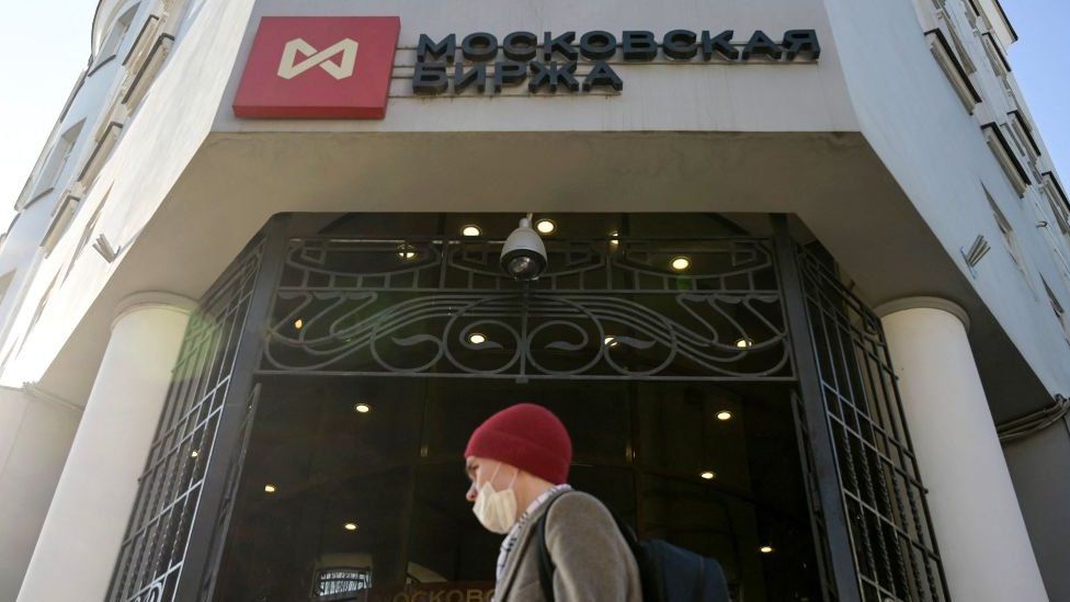A man walks past the Moscow's stock market building in downtown Moscow