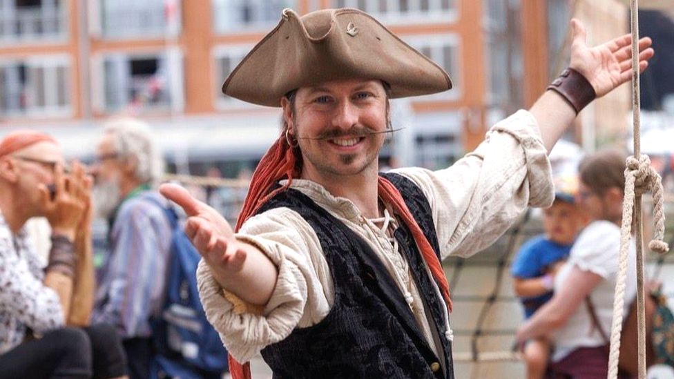 Gloucester Tall Ships Festival character in pirate costume smiling at the camera