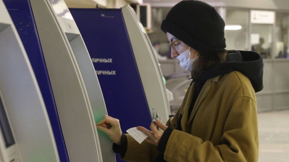 Woman using an ATM in Moscow