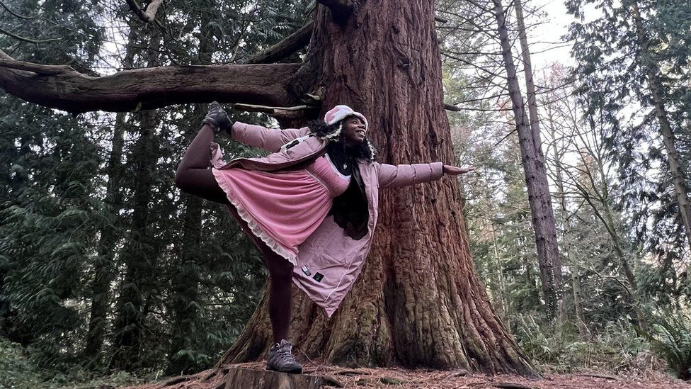 Dominique balancing on a tree stump
