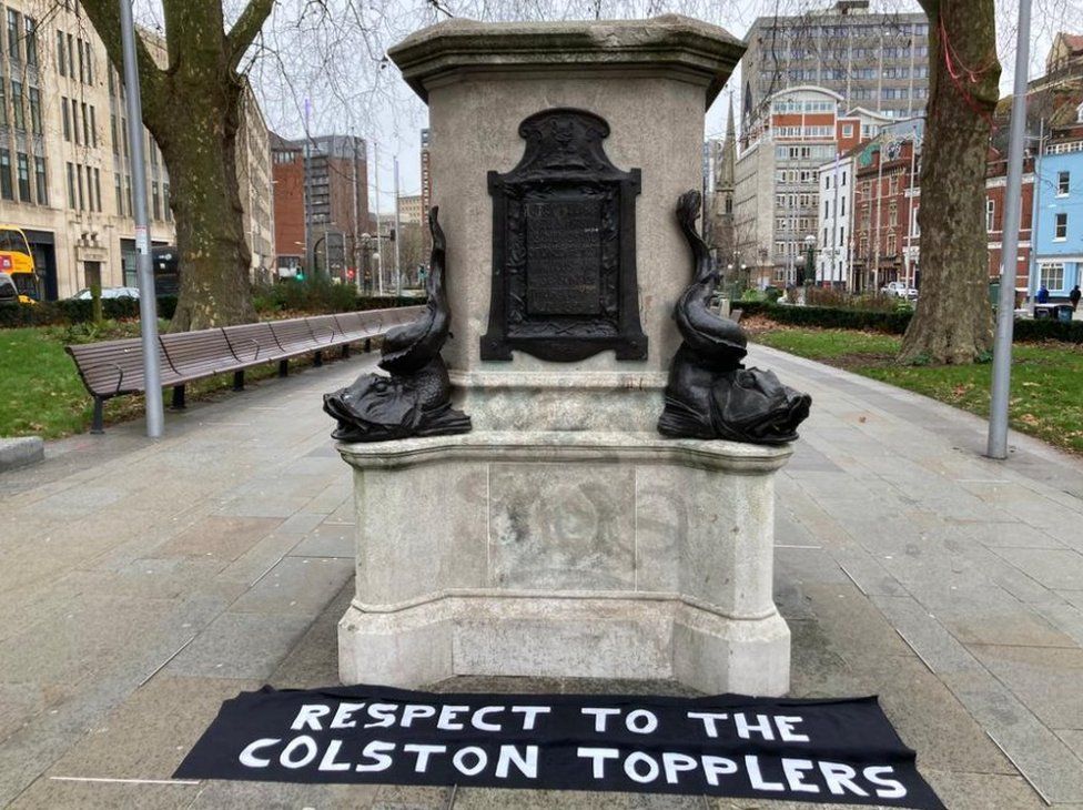 A banner reading: "Respect to the Colston Topplers" has appeared below the empty Colston plinth