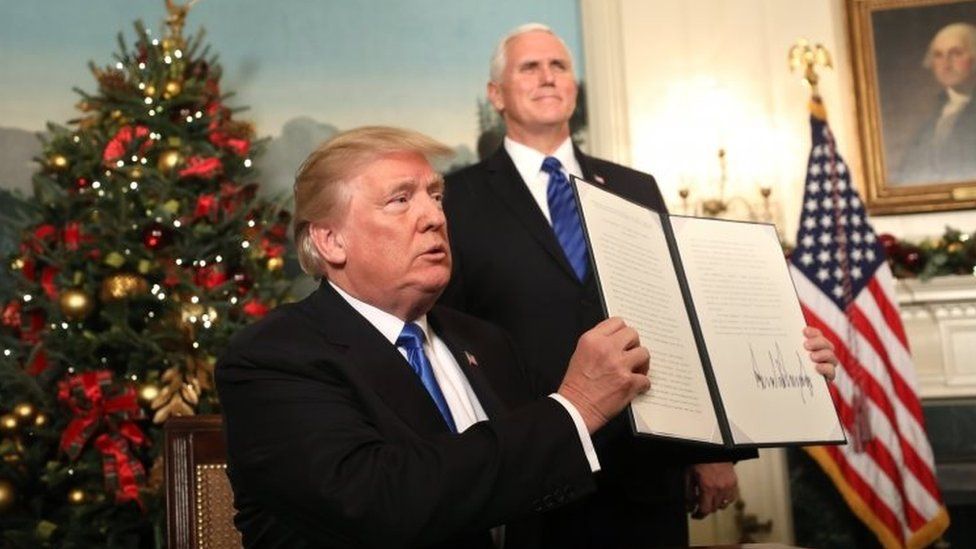 US Vice-President Mike Pence watches (right), as Donald Trump holds up his proclamation on Jerusalem's policy. Photo: 6 December 2017