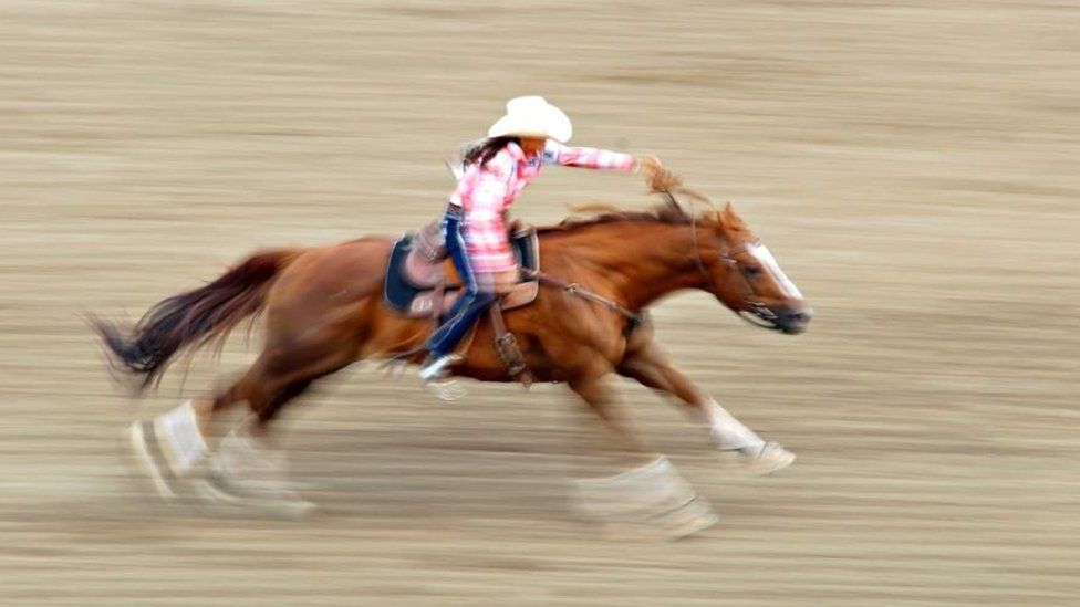 A rodeo competitor on horseback