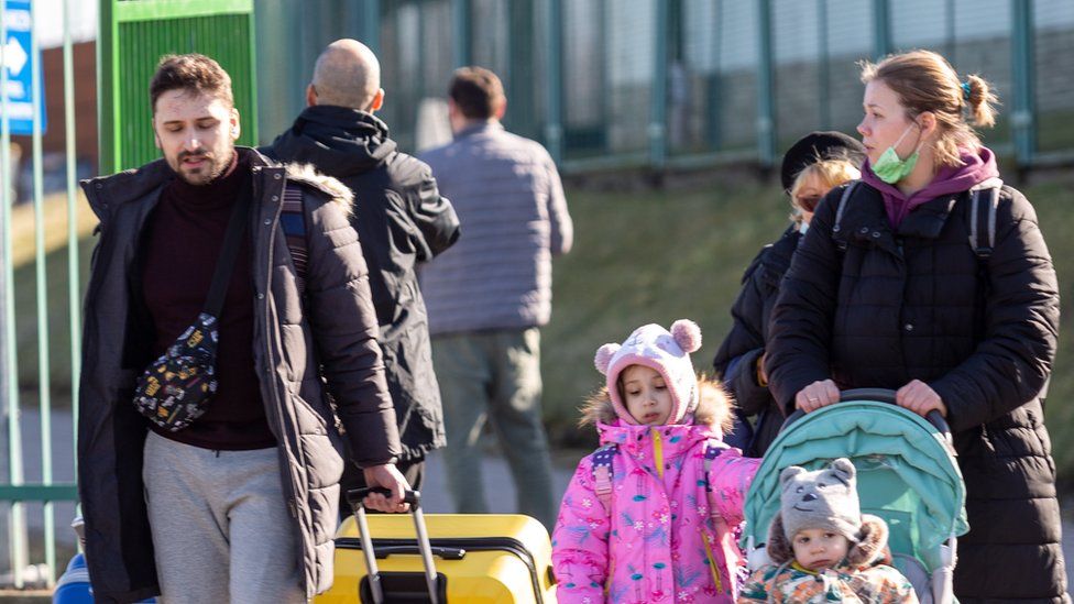 At the border between Poland and Ukraine, many people - including families with children - crossed on foot with suitcases