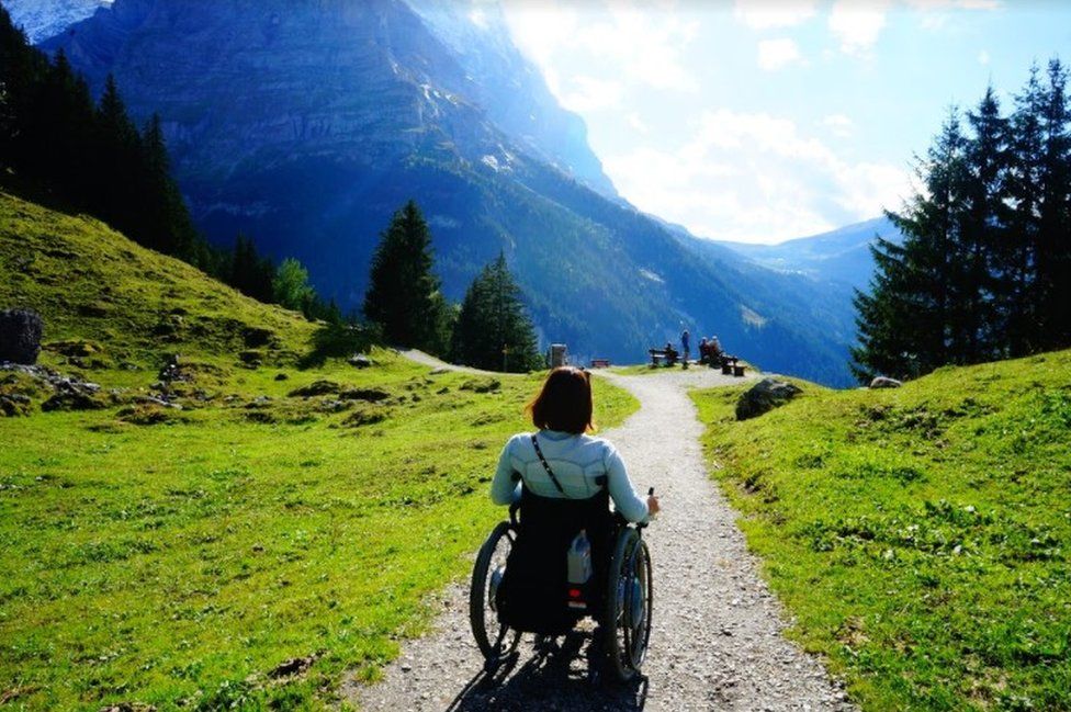 Seyoon Jane Hong on a moutain trail in her wheelchair