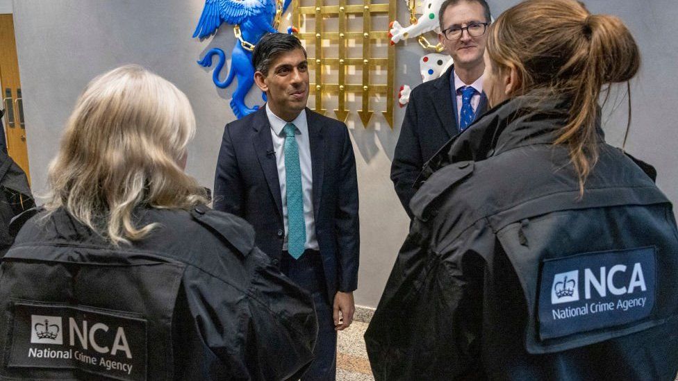 Rishi Sunak speaks with National Crime Agency (NCA) officers.