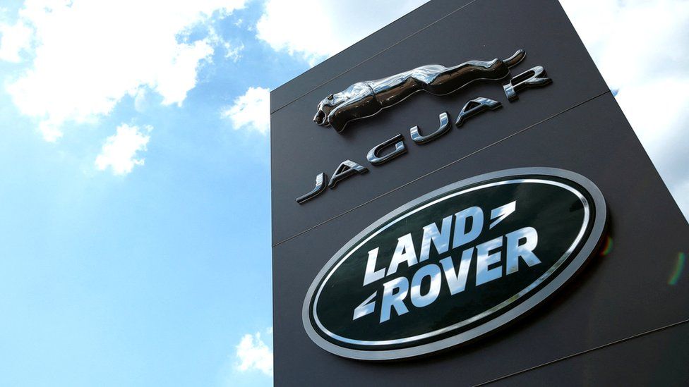 Jaguar Land Rover logo against a blue sky