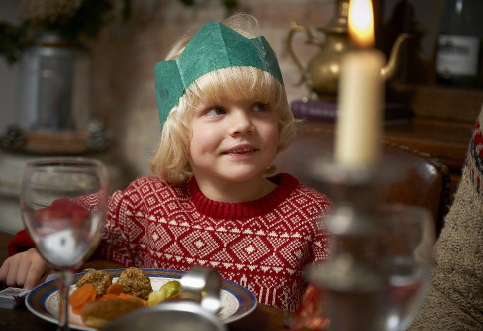 Child sitting at table for Christmas lunch