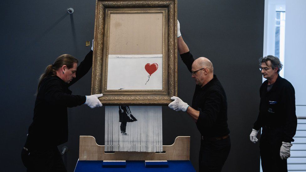 Banksy's Girl with Balloon after the canvas passed through a hidden shredder.