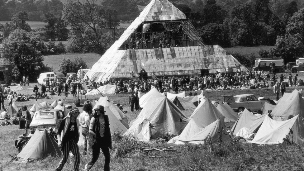 Tents and people in front of the Pyramid Stage