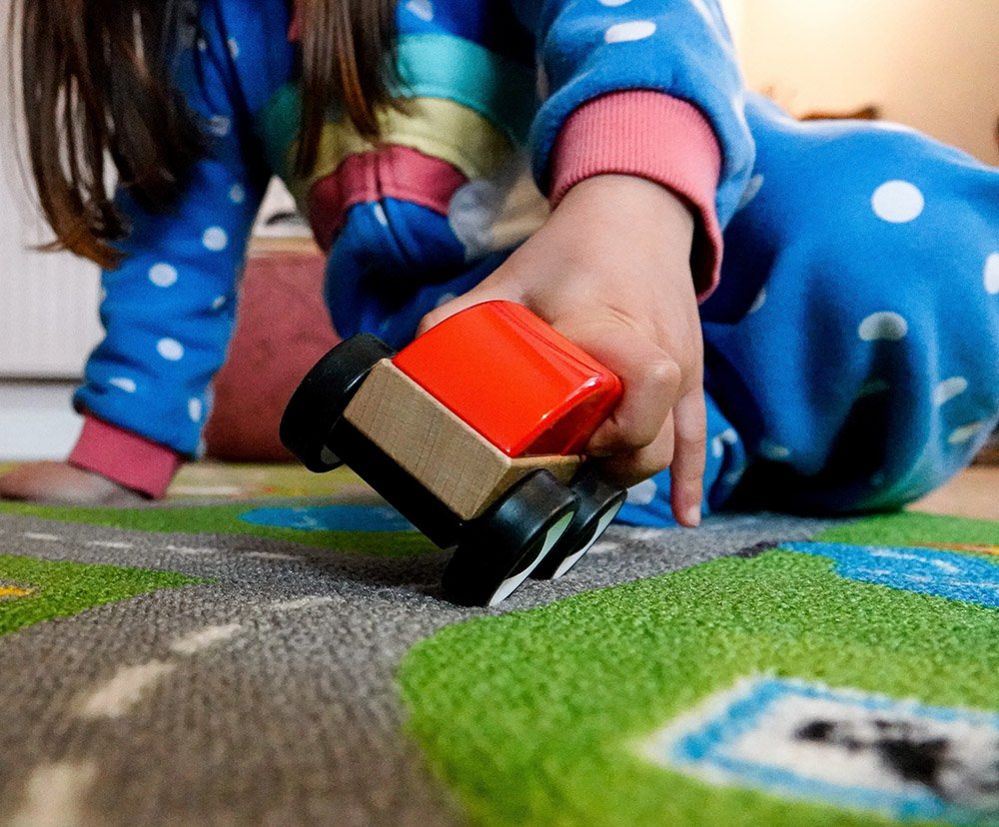 Girl playing with a toy car