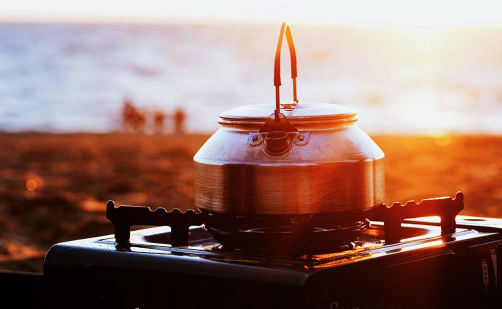 Boiling kettle on a beach