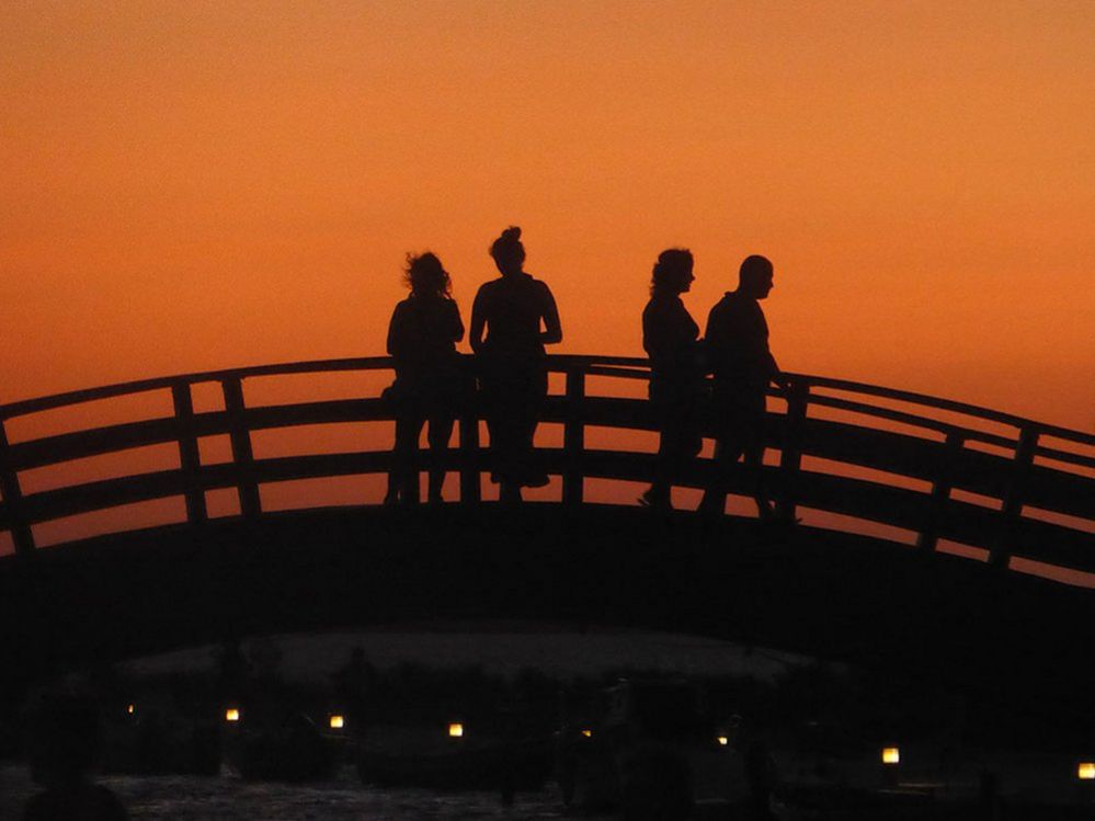 People on a bridge at dusk