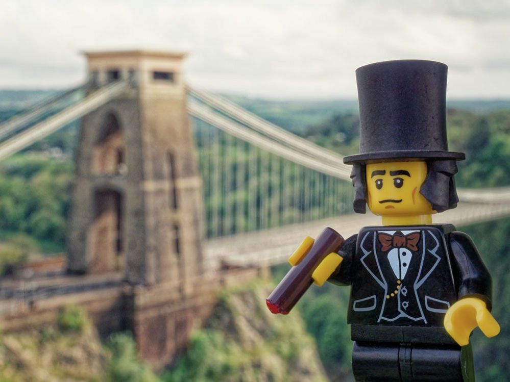 Lego figure of Brunel in front of the Clifton Suspension Bridge in Bristol