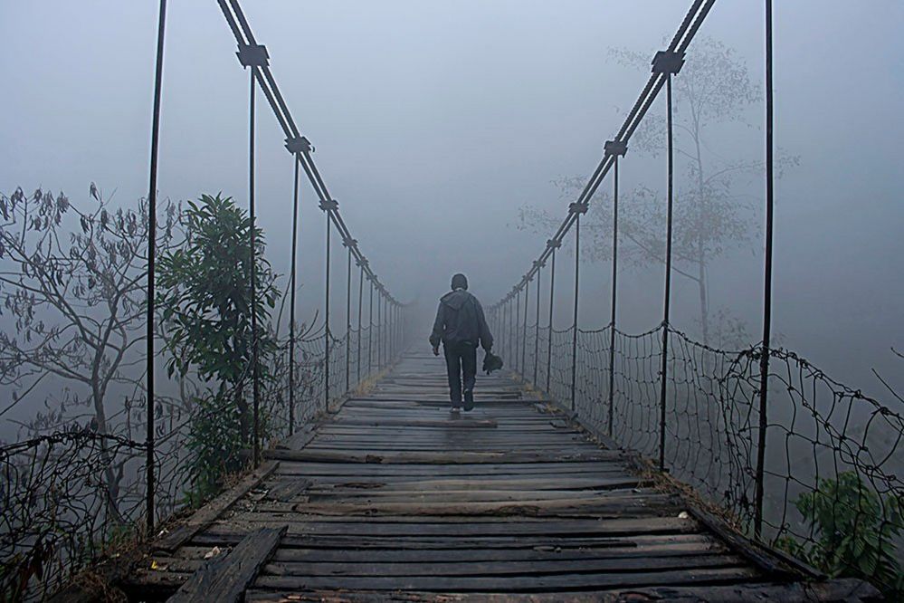 Figure on a bridge in mist