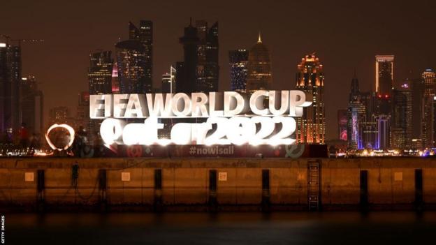 Fifa World Cup Qatar 2022 logo with Qatar skyline at night