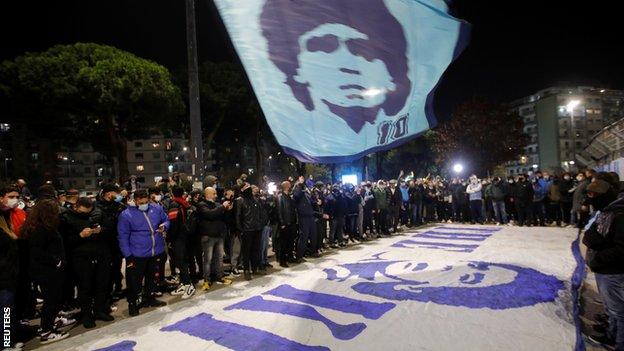 Fans gather outside Napoli's stadium to pay tribute to former player Maradona