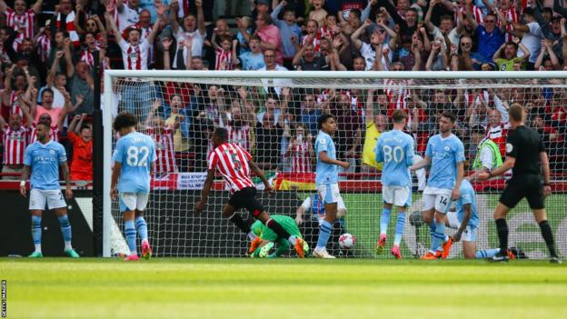 Ethan Pinnock wheels away after scoring the only goal in Brentford's victory over Premier League champions Manchester City