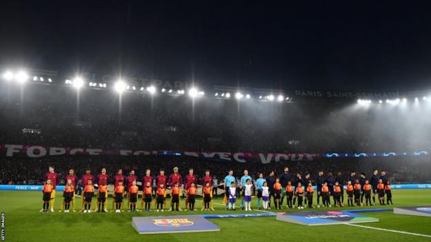 Paris St-Germain and Barcelona players line up on the pitch before their Champions League quarter-final tie