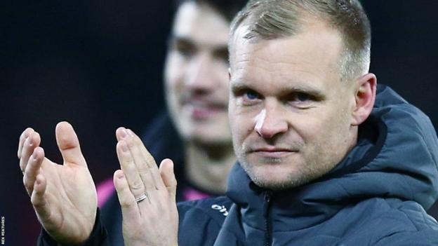 Bristol City manager Liam Manning applauds the fans after their penalty shootout loss to Nottingham Forest.