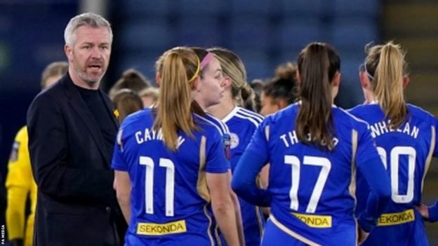 Leicester City manager Willie Kirk speaks to his players