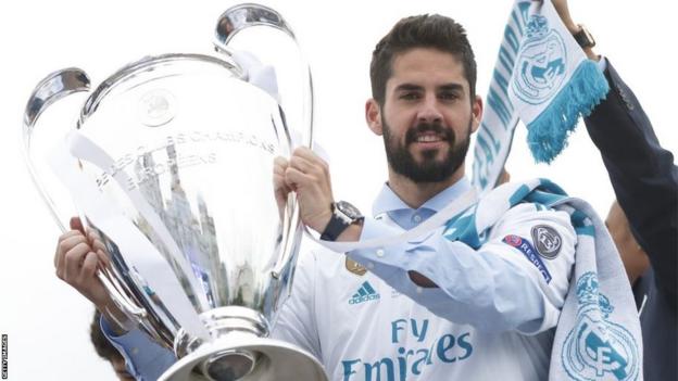 Isco holding the Champions League trophy