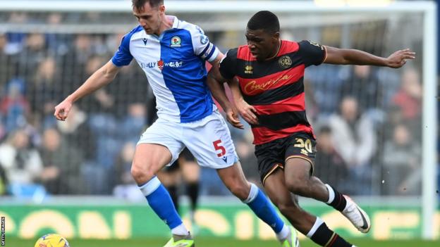 Blackburn Rovers' Dominic Hyam vies for possession with Queens Park Rangers' Sinclair Armstrong