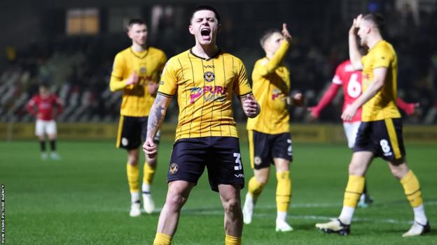 Adam Lewis celebrates his goal against Morecambe