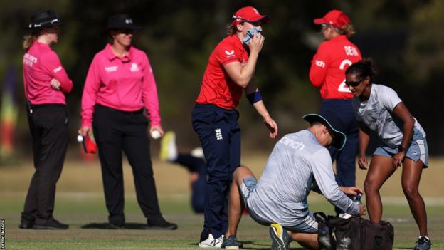 England captain Heather Knight receives treatment after being hit in the face by the ball in their ICC Women's World Cup warm-up match against South Africa