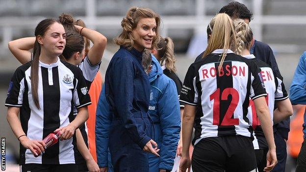 Amanda Staveley on the pitch with the Newcastle players