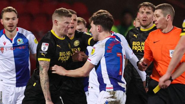 Blackburn and Wigan players clash