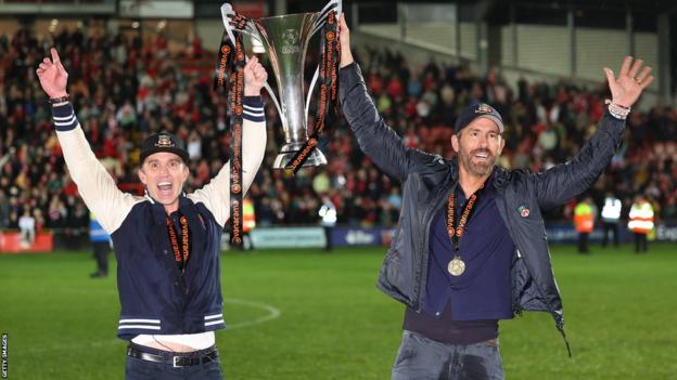 Wrexham owners Rob McElhenney and Ryan Reynolds celebrate the club's promotion into League Two