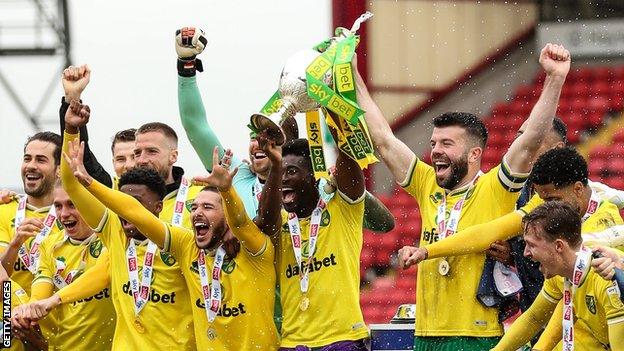 Norwich City players celebrate winning the Championship