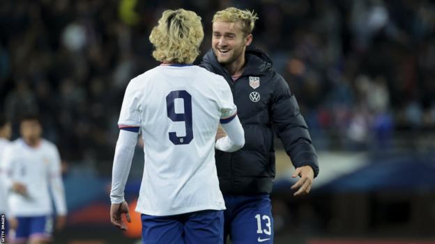 Duncan McGuire greets an international team-mate