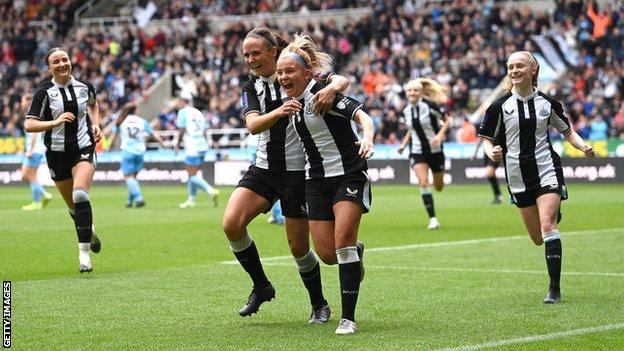 Newcastle player Beth Guy celebrates with captain Brooke Cochrane