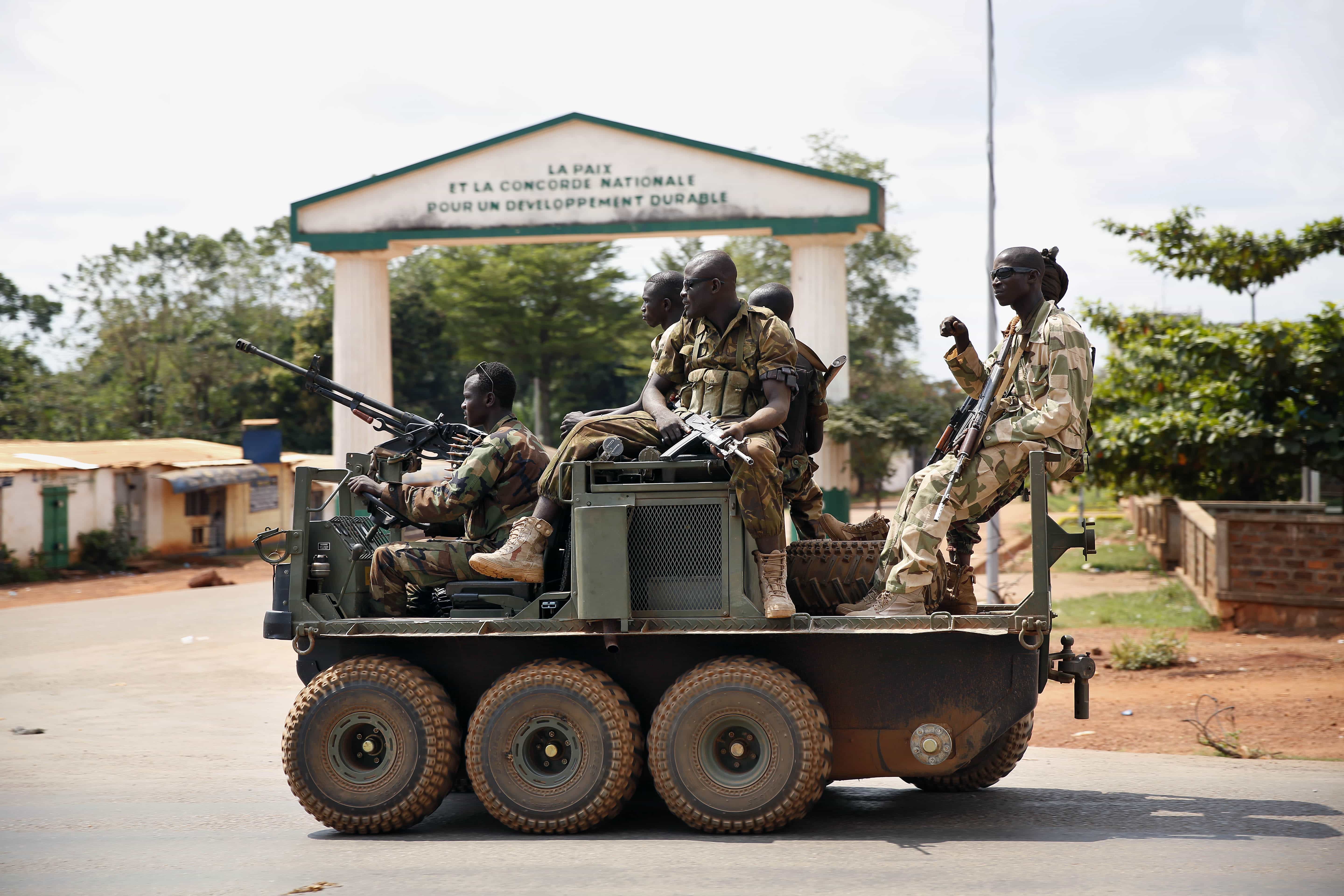 Seleka soldiers race through Bangui, Central African Republic, 5 December 2013 as gunfire and mortar rounds erupt in the town, AP Photo/Jerome Delay