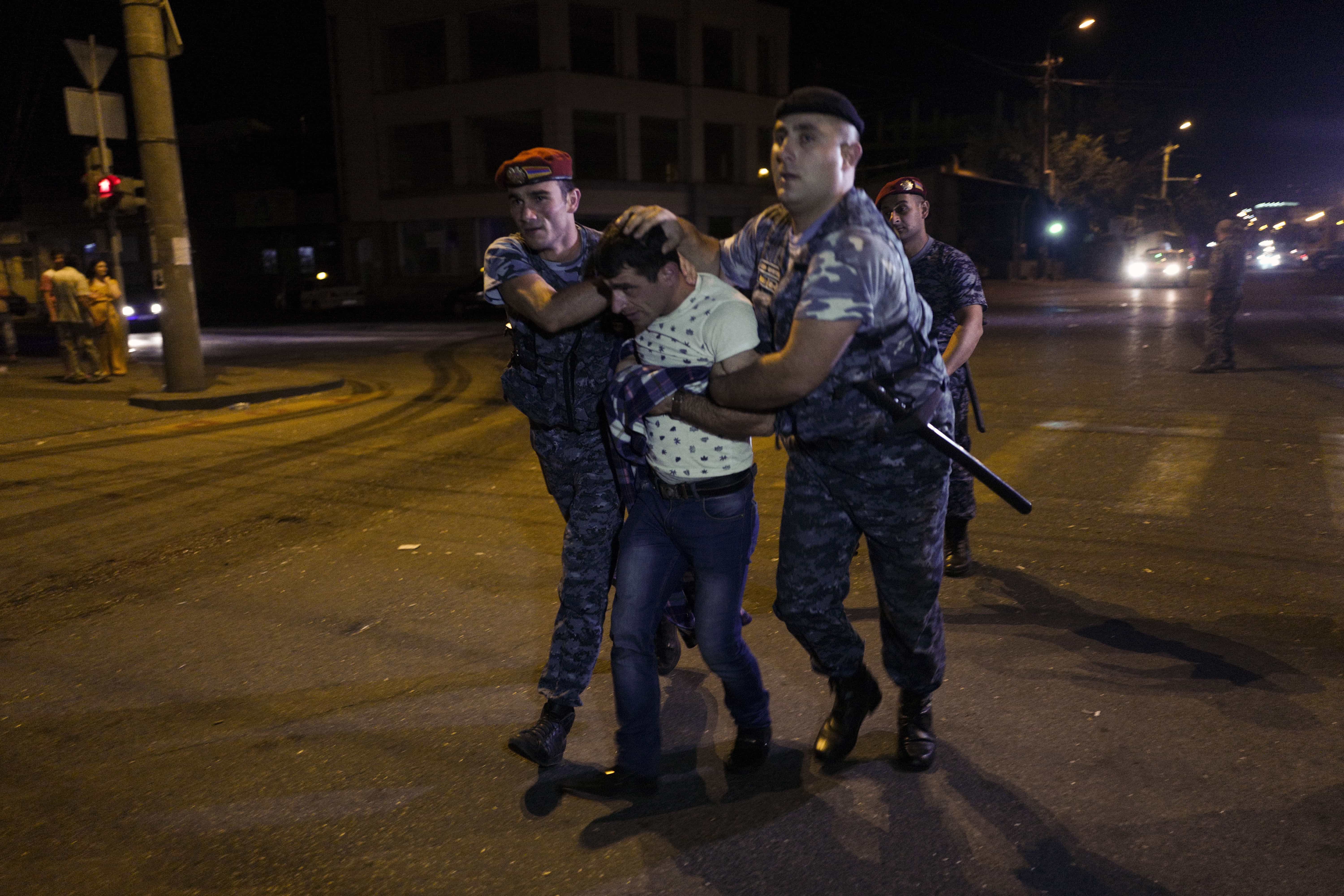 Police officers detain a supporter of the armed group who have been holding a police station in Yerevan, Armenia, 27 July 2016., Vahan Stepanyan/PAN Photo via AP