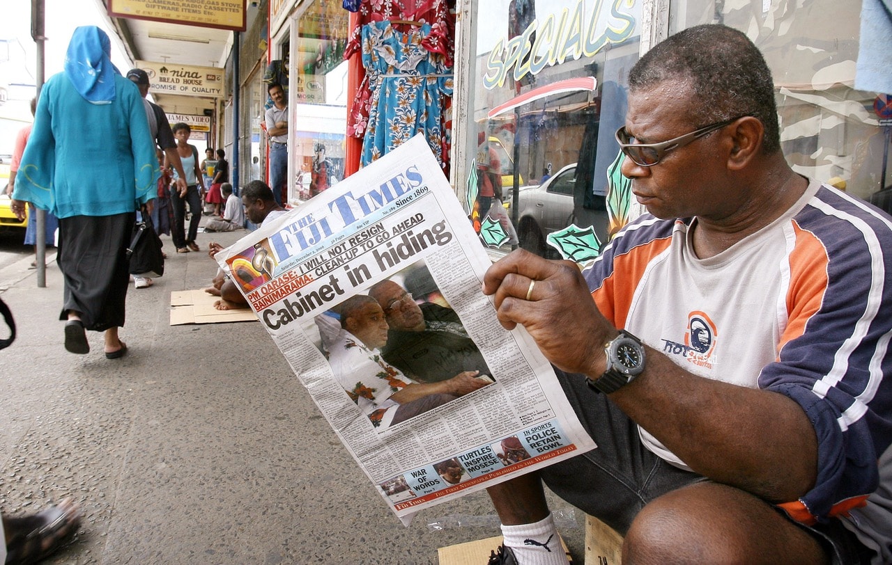 A man reads a copy of the "Fiji Times", in Suva, Fiji, 2 December 2006, WILLIAM WEST/AFP/Getty Images