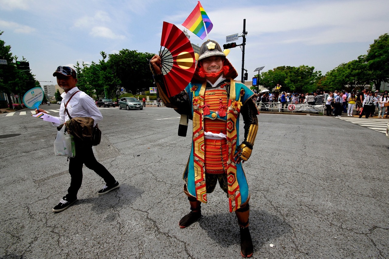 A participant dressed in an ancient samurai warrior costume with the rainbow flag on his helmet poses before the Tokyo Rainbow Pride parade, 7 May 2017, AP Photo/Shizuo Kambayashi