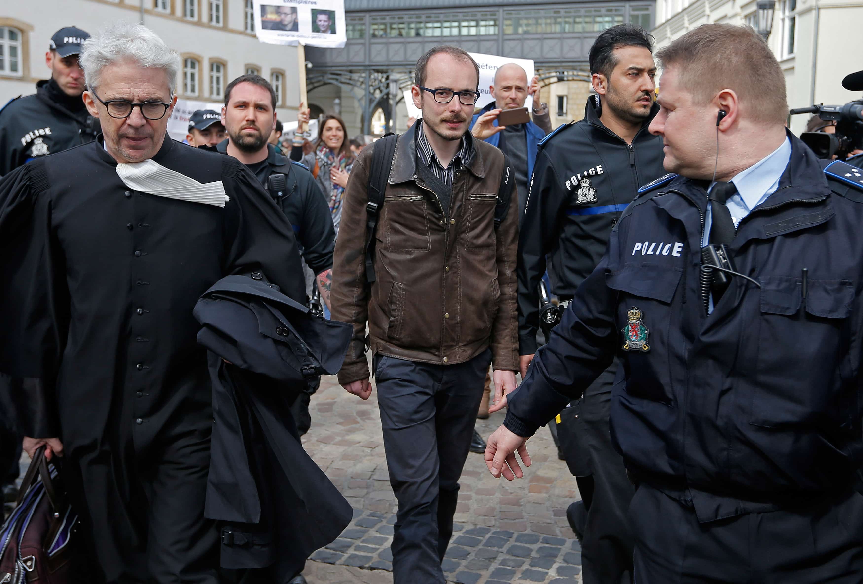 Former PricewaterhouseCoopers employee Antoine Deltour (C) and his lawyer William Bourdon (L) leave the court after the first day of the LuxLeaks trial in Luxembourg, 26 April 2016, REUTERS/Vincent Kessler