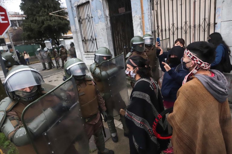 Mapuche indigenous protesters are dispersed by police special forces in Santiago, Chile, 4 August 2020; they were protesting in support of actions in the Araucania region where indigenous communities are reclaiming lands seized by the state and sold to logging companies. Photo by MARIO QUILODRAN/AFP via Getty Images