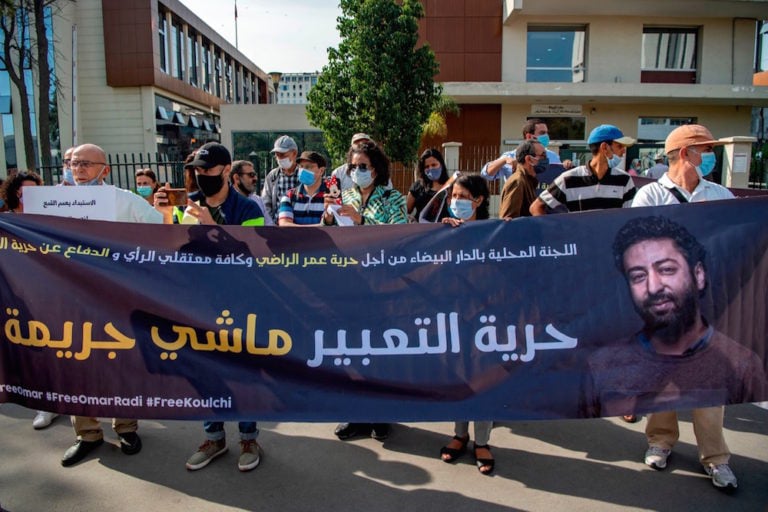 The mother (C-R) of Omar Radi (whose photo appears on the banner), a prominent Moroccan journalist on trial over charges of rape, takes part in a demonstration, Casablanca, 22 September 2020, FADEL SENNA/AFP via Getty Images