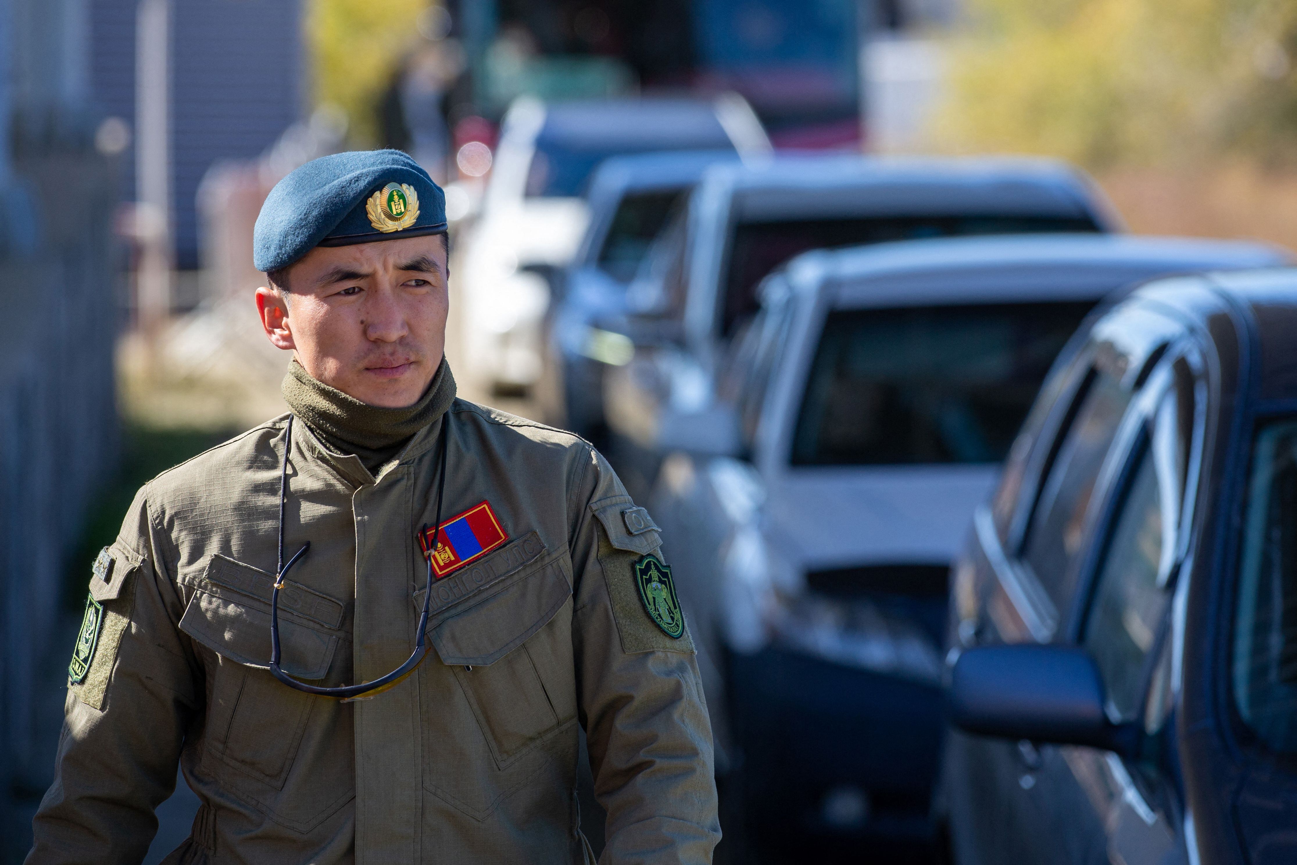 A Mongolian border guard inspects vehicles arriving from Russia on September 25 in Altanbulag. 