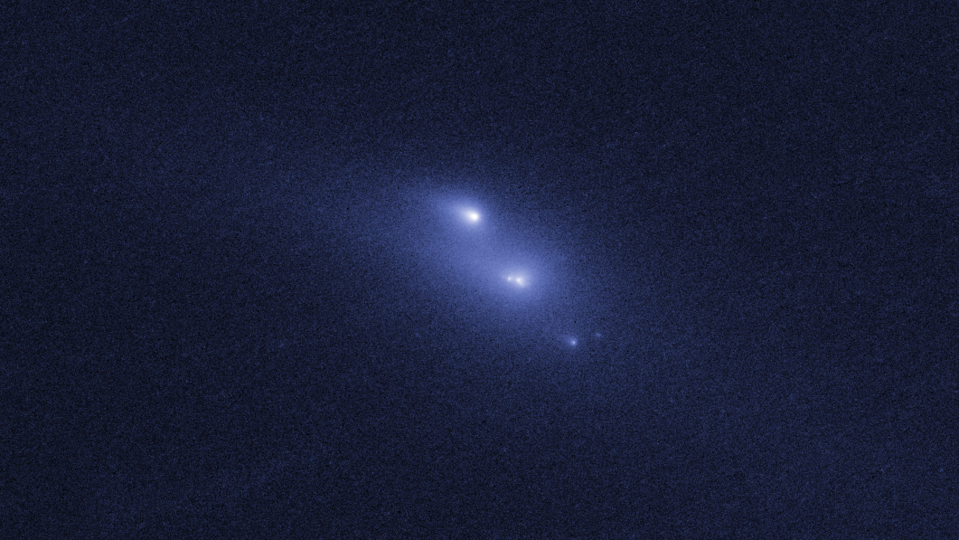Two large and one smaller bright, blue-white dots surrounded with a blue cloud.