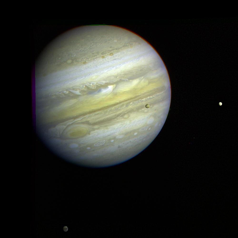 Jupiter, its Great Red Spot and three of its four largest satellites are visible in this photo taken Feb. 5, 1979, by Voyager 1. Io, Europa, and Callisto are seen against Jupiter disk.
