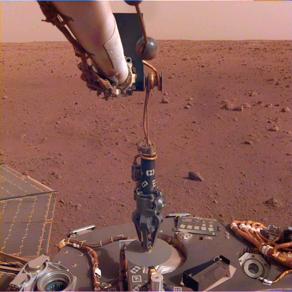 The robotic arm on NASA's InSight lander deployed its Heat Flow and Physical Properties Package (HP3) instrument on the Martian surface on Feb. 12, 2019.