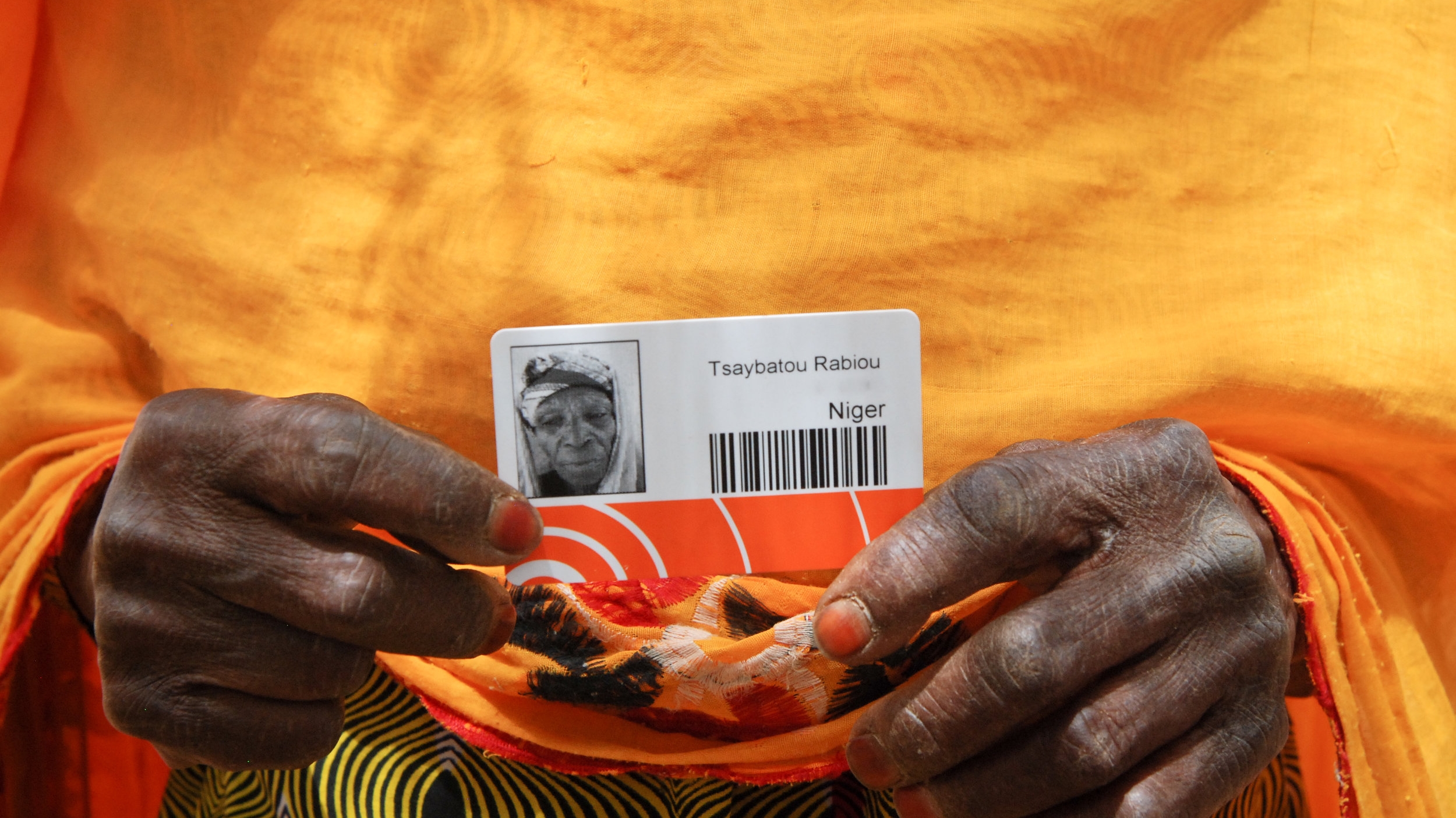 Ttle Tsaybatou Rabiou, a widow of 63, showing her card