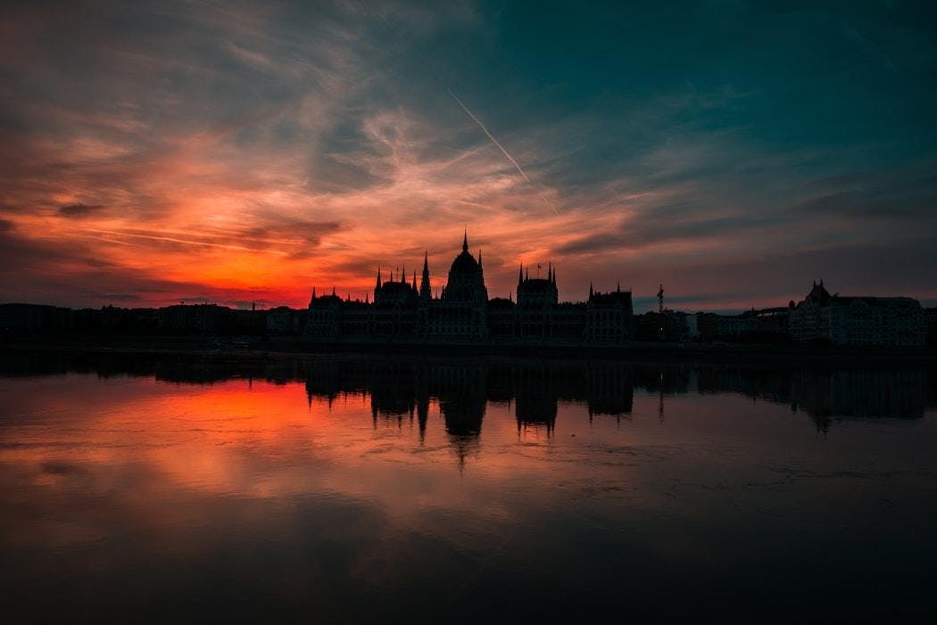 Silhouette of the Hungarian Parliament building reflected on the Danube at Sunset