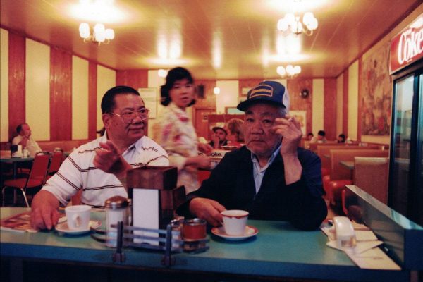 At New Outlook Café in Saskatchewan, Canada, Founder Noisy Jim sits with cousin Chow Fong. 